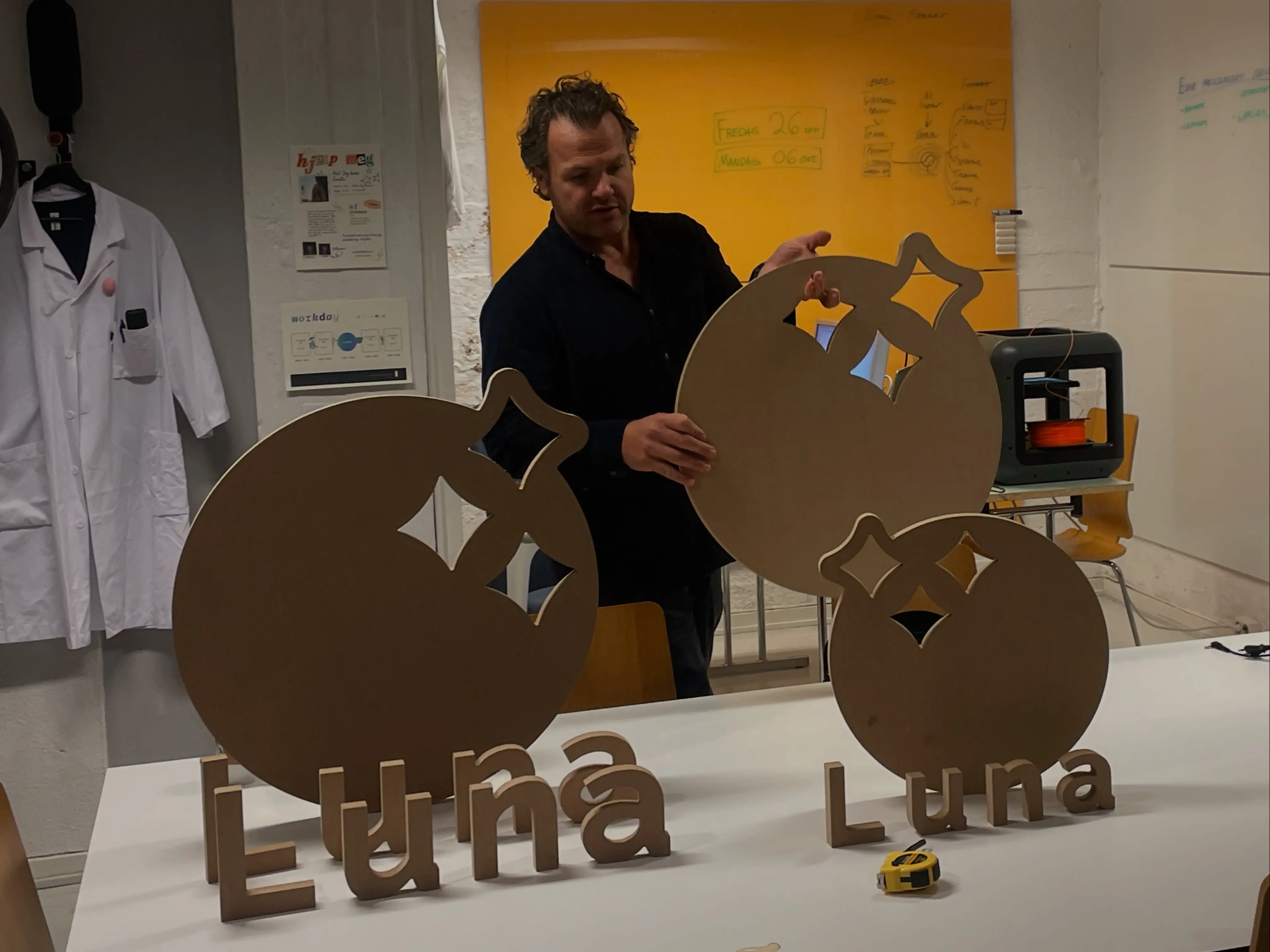 Team creating Luna logo signs